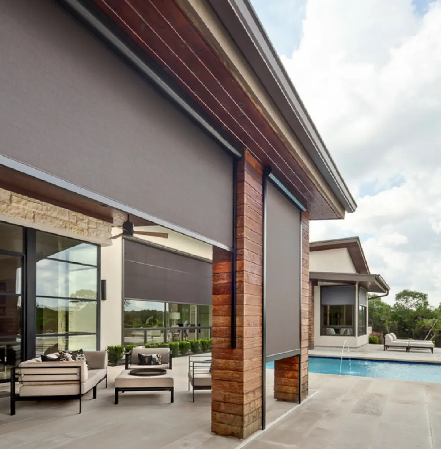 Backyard of a home with custom designed and built exterior screens on the windows.