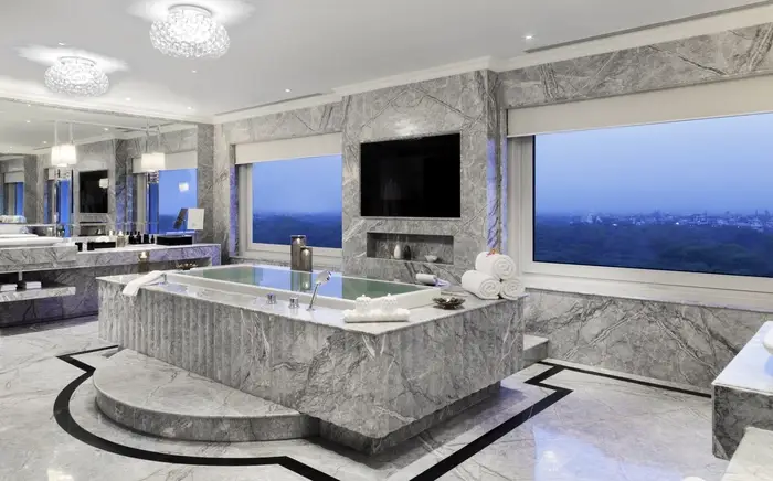 Gray marble bathroom at the Palace Hotel, with custom roller shades on the windows.