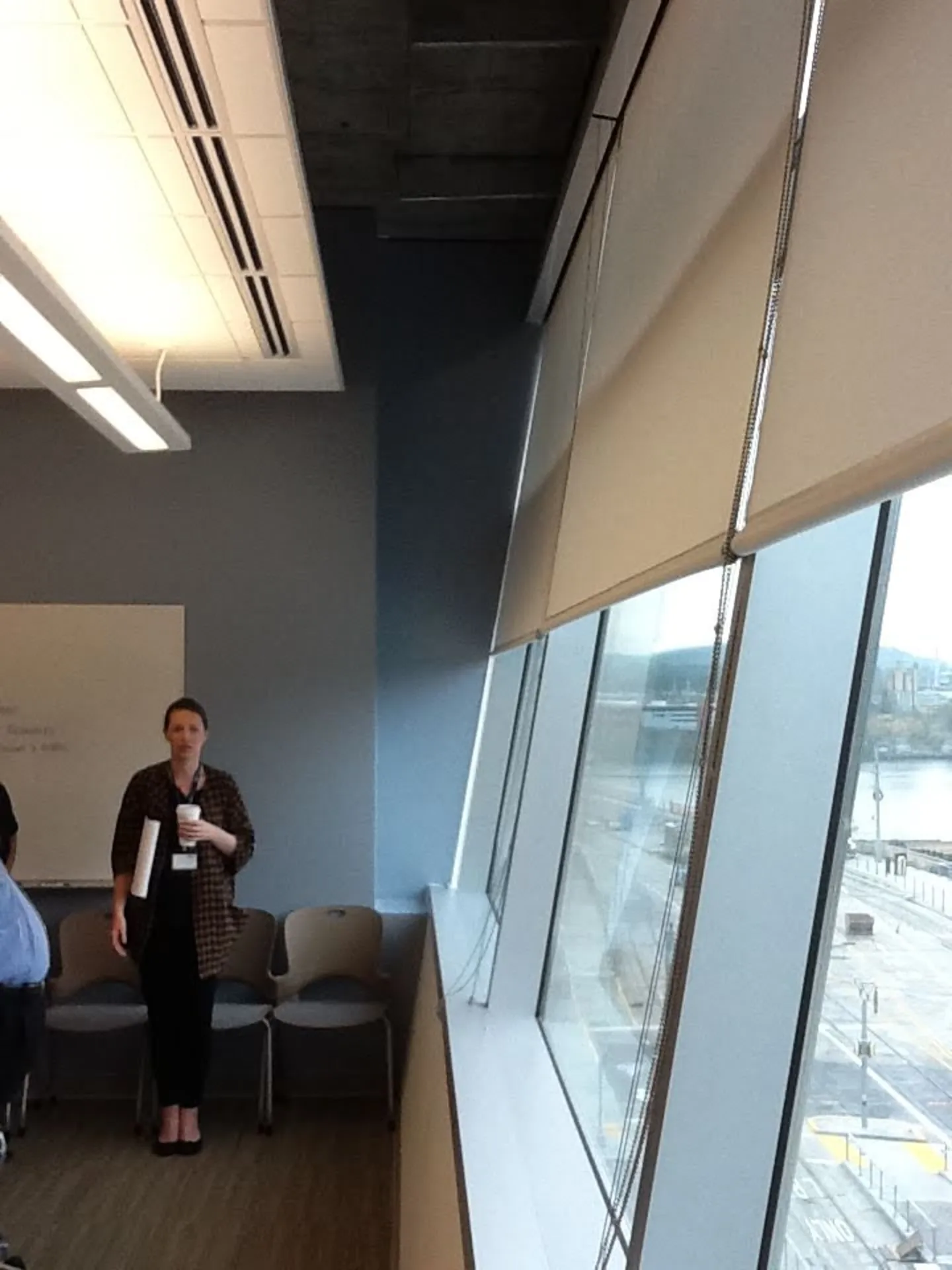 Roller shades installed in an office building at an angle to match the windows.