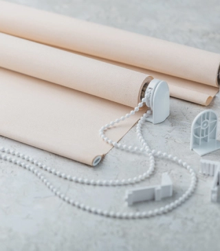 Skyco Drapery Systems 4 Peach-colored roller shade, disassembled on the ground.
