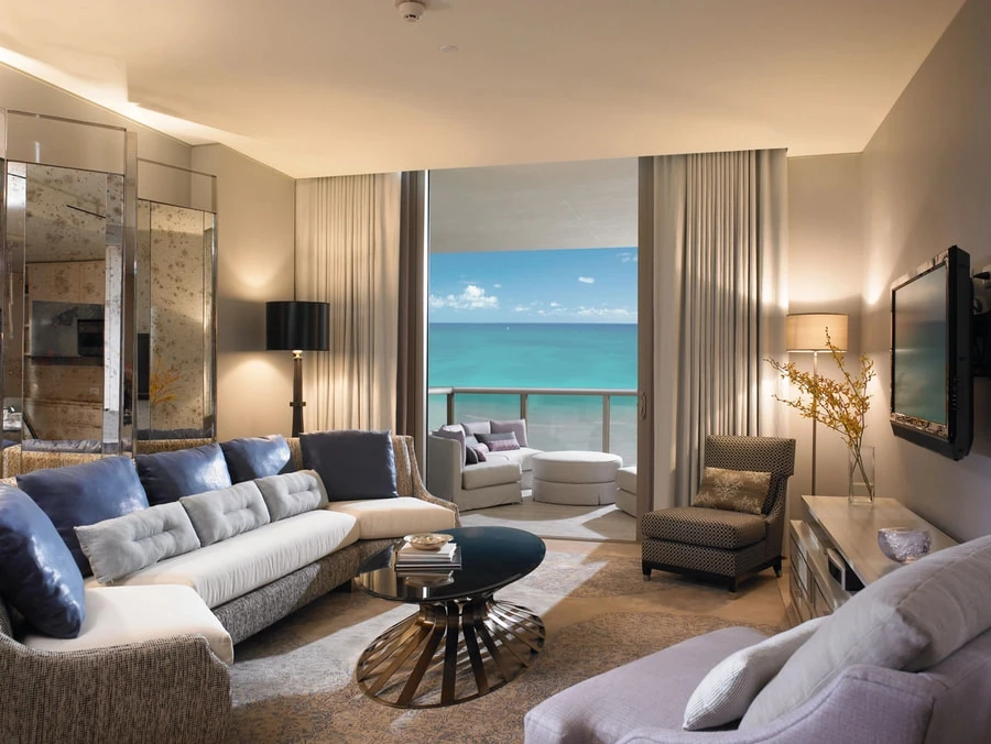 St. Regis Resort with ocean view. There are drapes framing the large window.