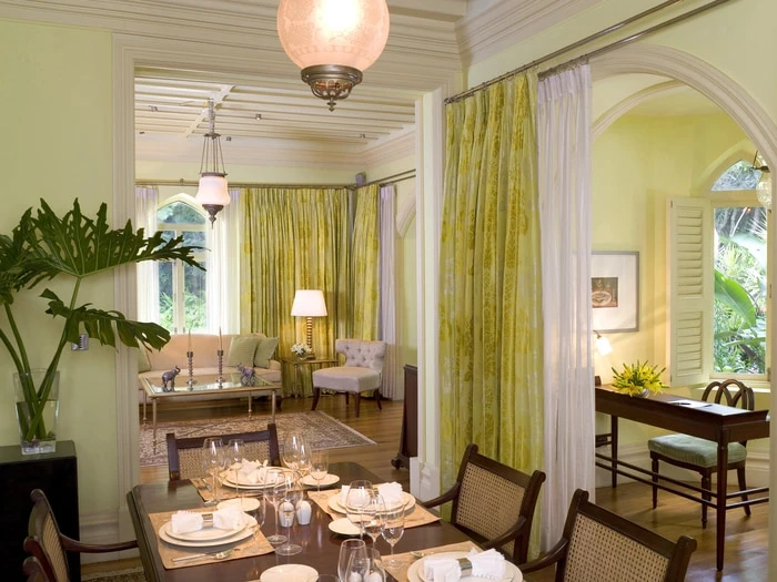 Several rooms in a Taj West End Hotel suite, separated by green drapes.