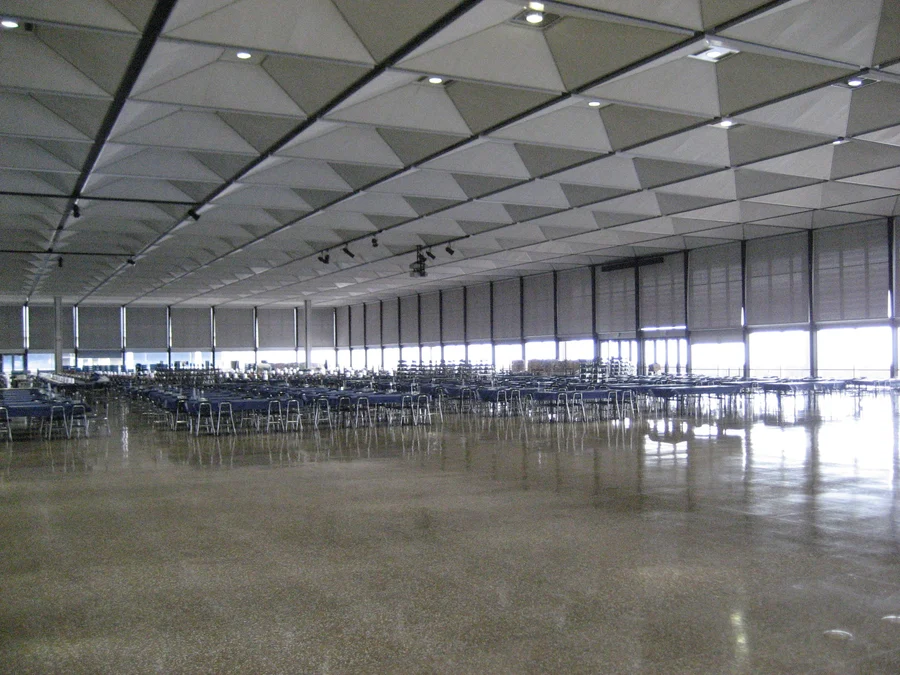 U.S. Air Force dining room with roller shades on all of the windows.