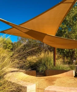Shade sail covering a garden area.