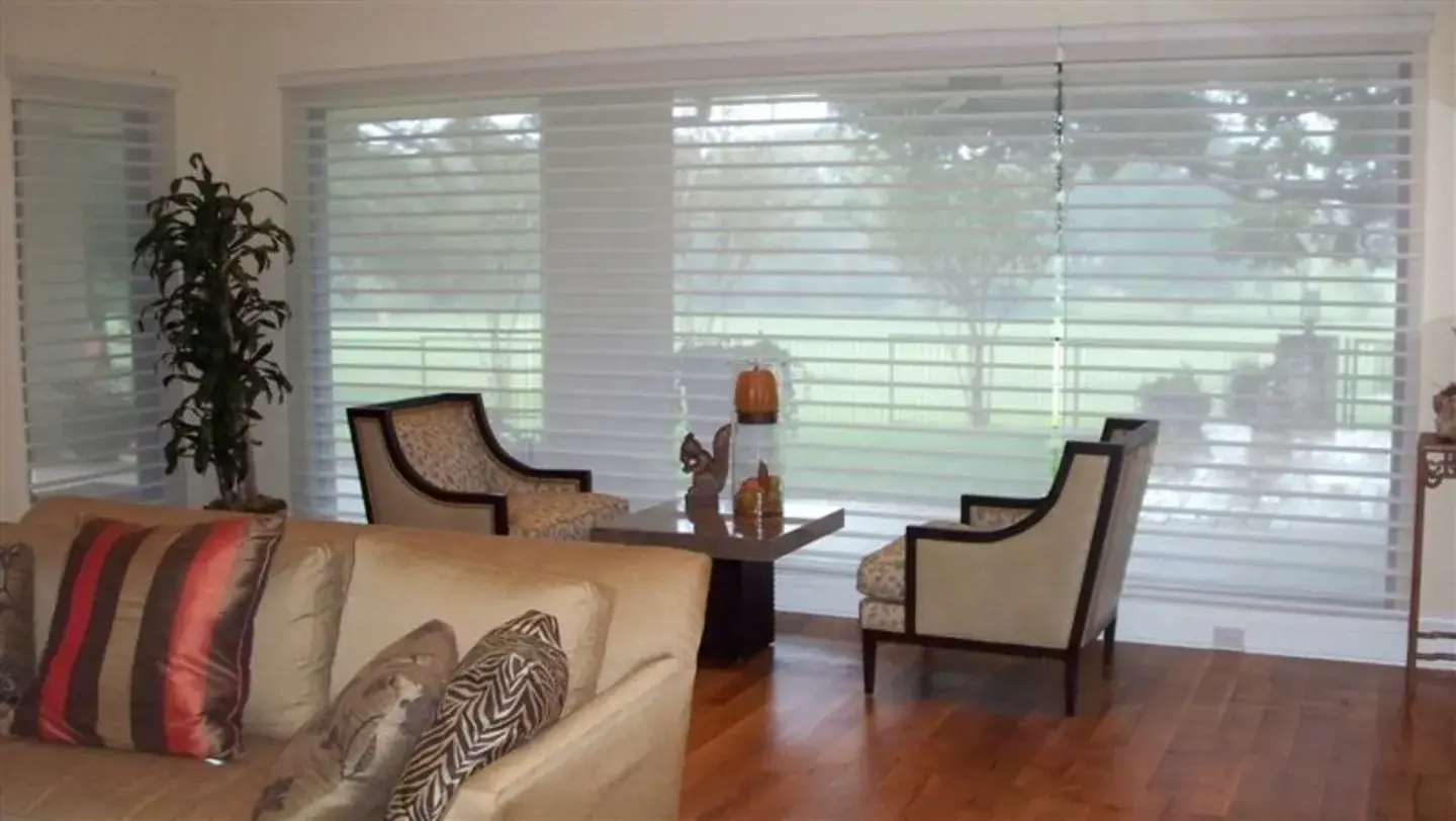 Roman shades fully-lowered in a living room, providing privacy and shade.