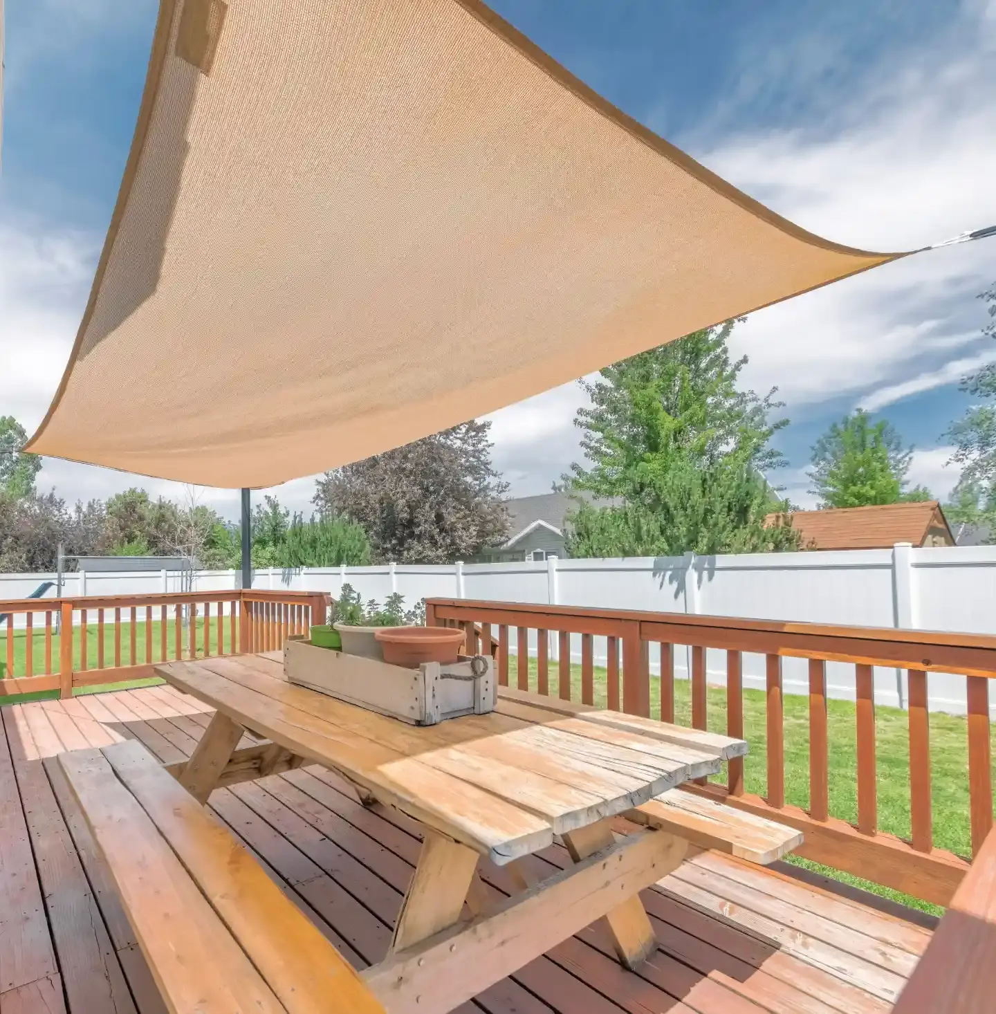 Twister Sail installed to cover an outdoor patio with a picnic table.