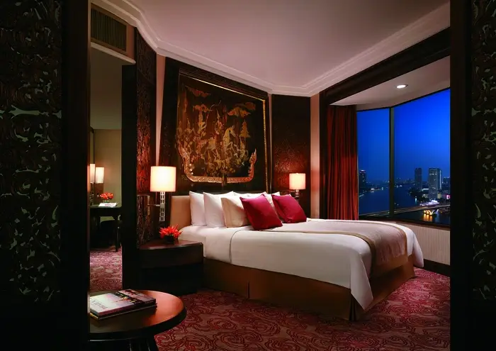 Guest room of a hotel. Red drapery covers the windows, providing privacy.