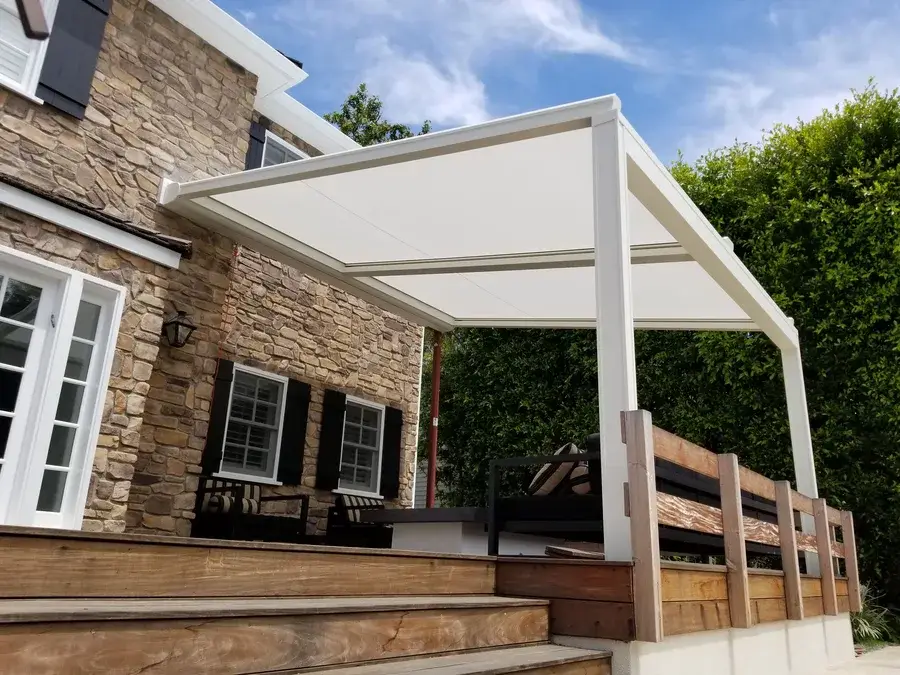 White roller shade covering a large outdoor patio in Brentwood.