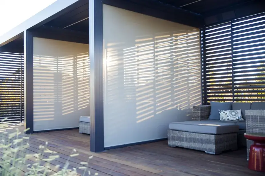 Louvered wooden shutters creating separation between several cabanas.
