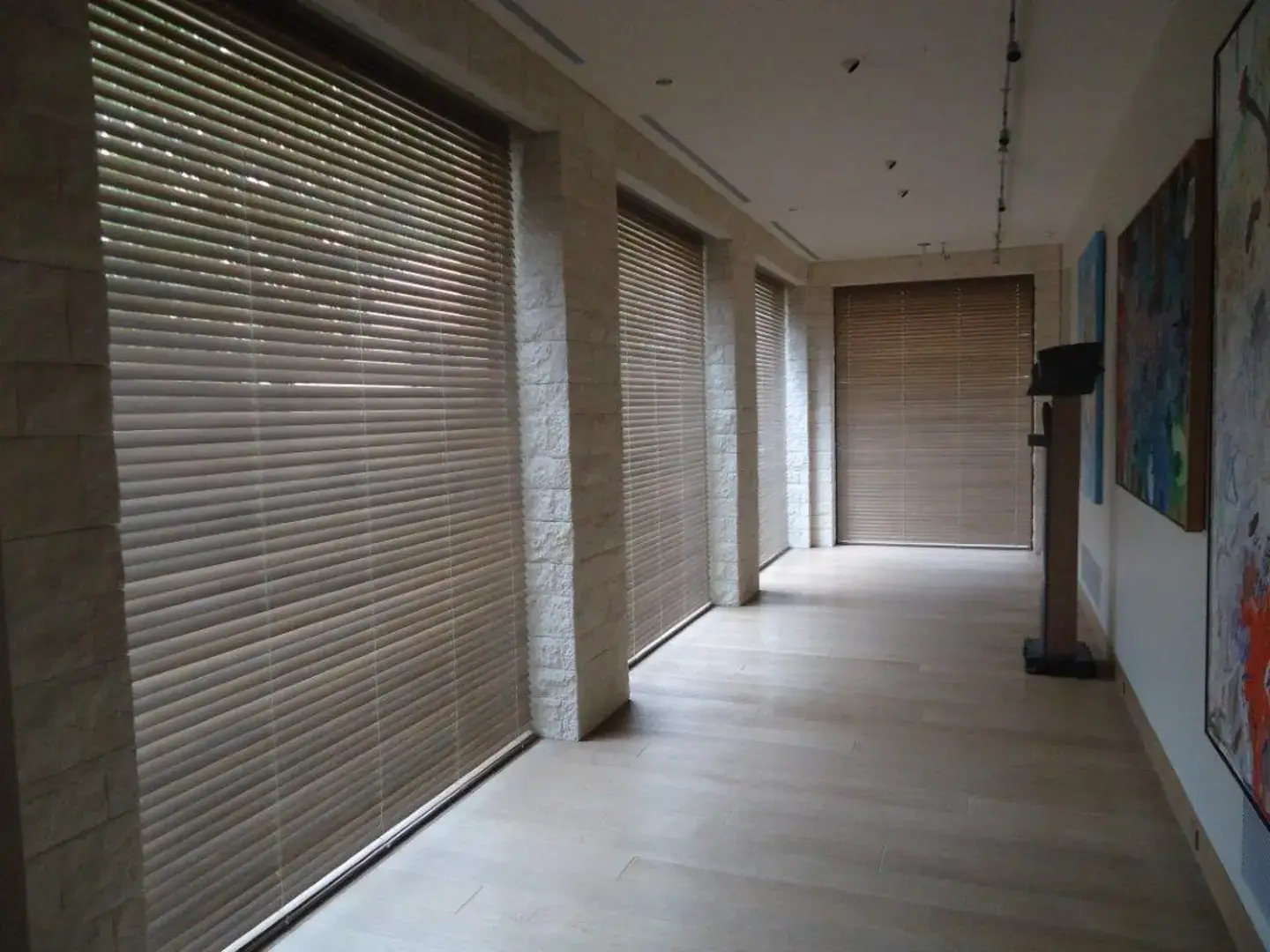 Large hallway with custom wooden blinds providing shade and privacy.